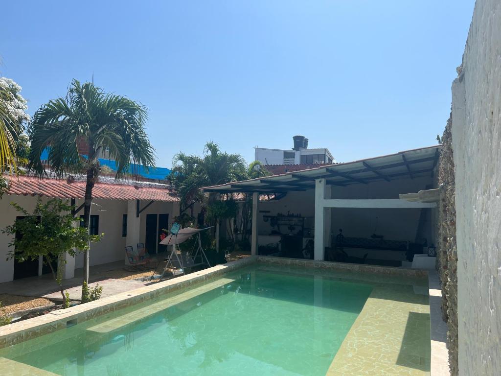 a swimming pool in front of a house at Casa Torices Real 12 in Cartagena de Indias
