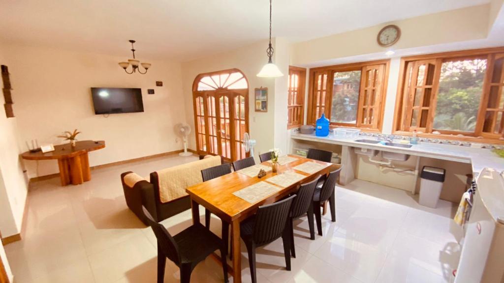 eine Küche und ein Esszimmer mit einem Holztisch und Stühlen in der Unterkunft Apartamento de PATTY in Puerto López