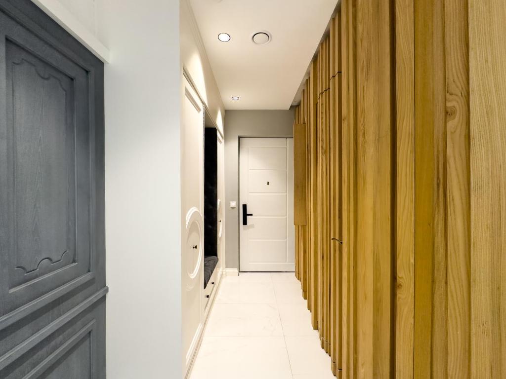 um corredor com paredes de madeira e uma porta em King David Residence Tbilisi - 2 Bedroom Luxury Apartment em Tbilisi