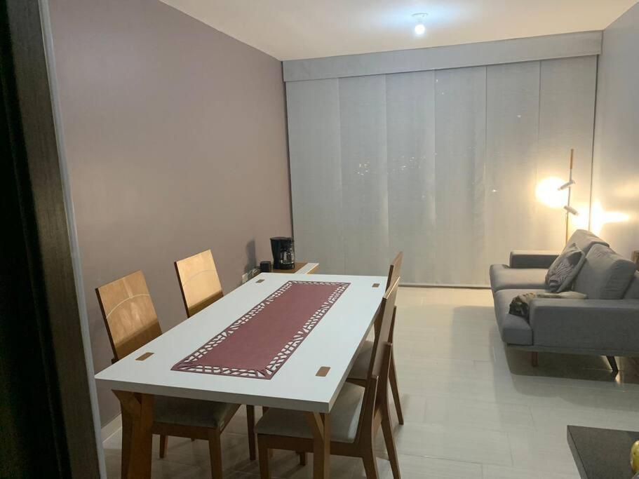 a living room with a table and chairs and a couch at Apto con tres aires en villa campestre Barranquilla in Barranquilla