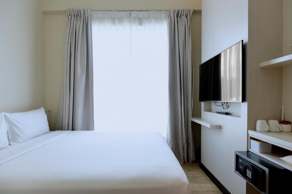 Postel nebo postele na pokoji v ubytování Cititel Express Kota Kinabalu