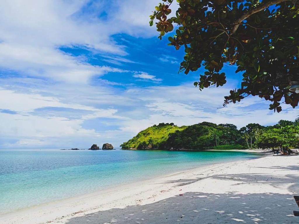 a beach in the philippines with islands in the background at Aglicay Beach Resort in Romblon