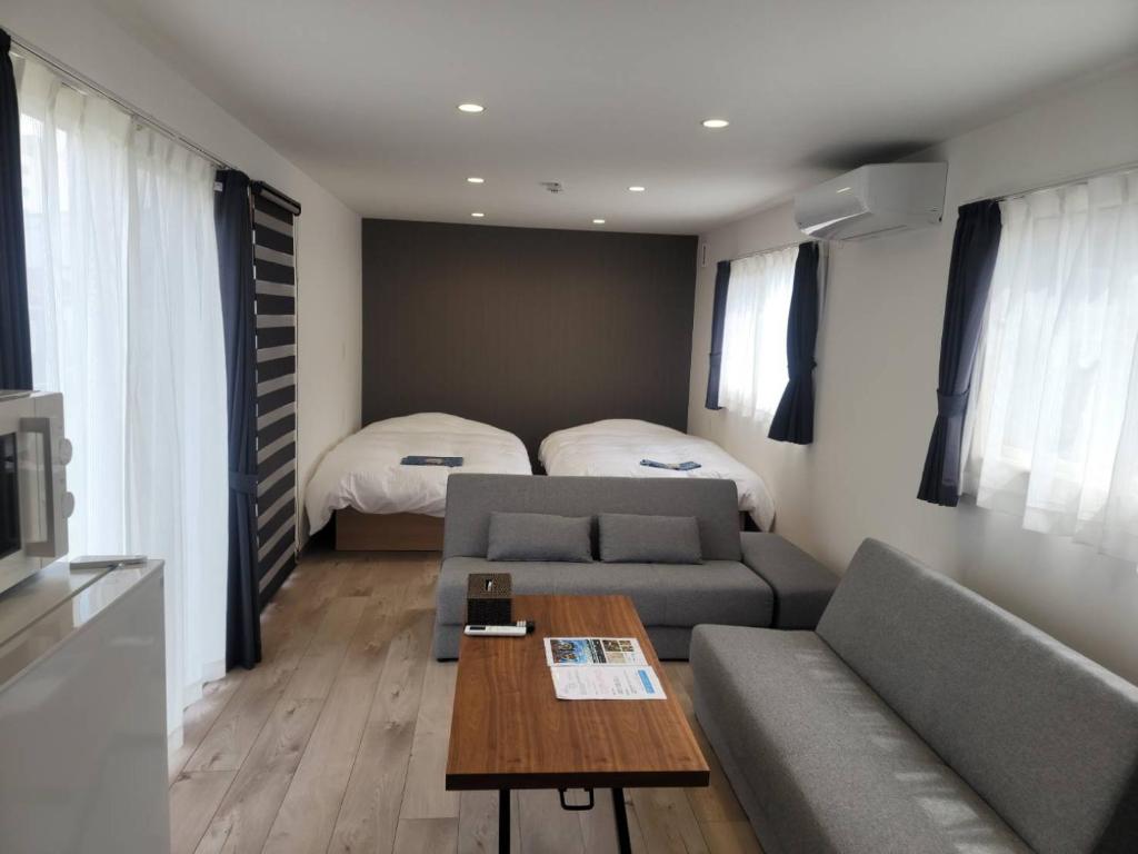 a living room with a couch and a bed at TOYA Center Village in Lake Toya