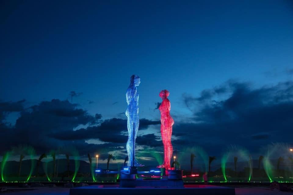 two lit up skeletons standing in a field at night at Seaview Hotel - Arena Cam Ranh Resort in Cam Ranh