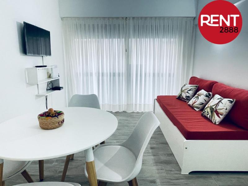 a living room with a red couch and a white table at Rent Aguero in Buenos Aires