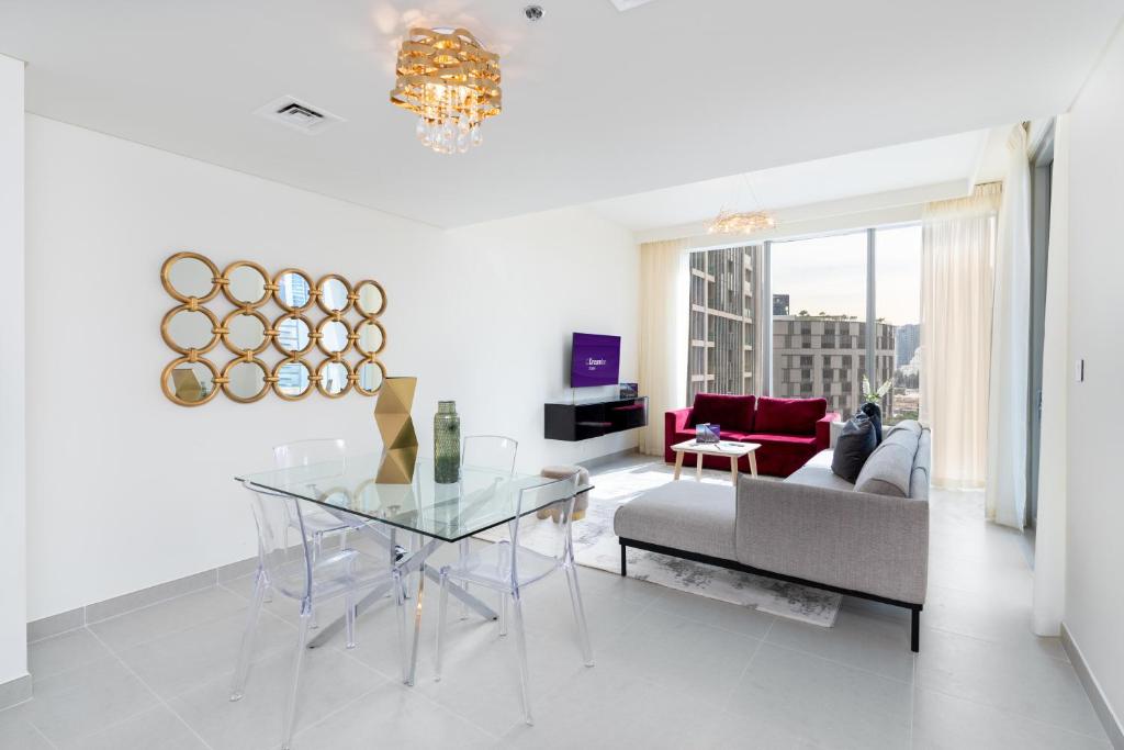 a living room with a glass table and a couch at Dream Inn Apartments - Forte - The Opera District in Dubai