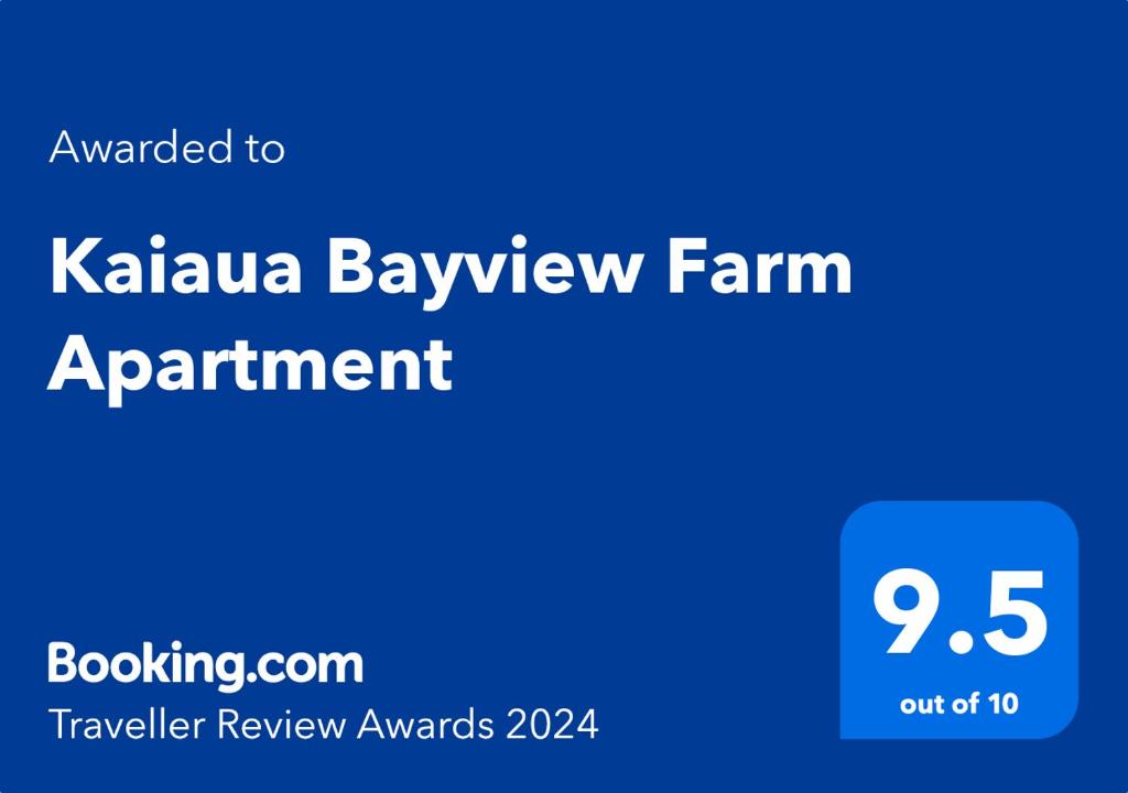 a blue sign with the words kalamaja bayev farm appointment at Kaiaua Bayview Farm Apartment in Auckland