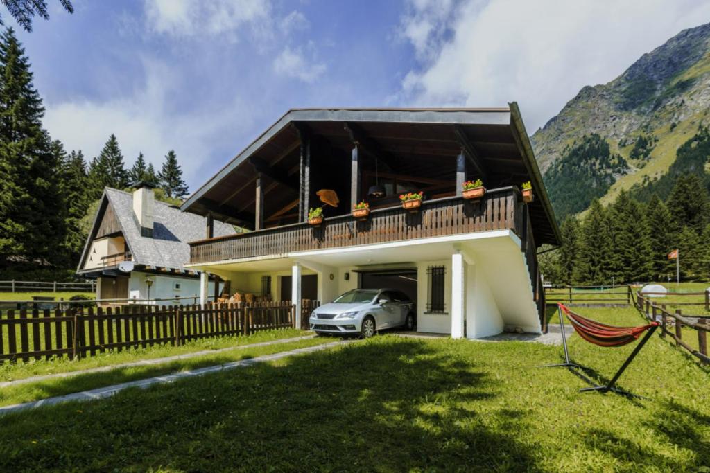 a house with a car parked in front of it at Chalet Soleada - Happy Rentals 