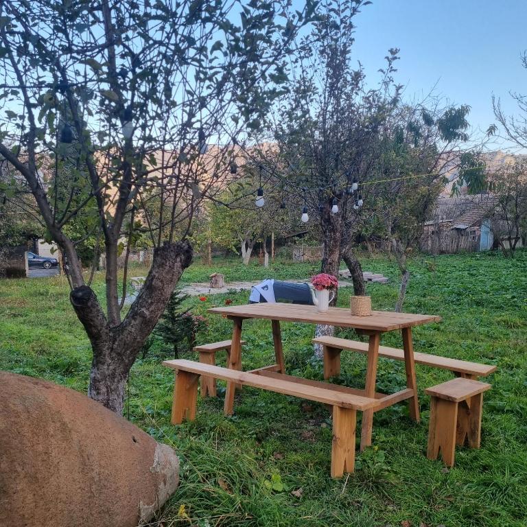 a picnic table and bench in a field at Hooni_guesthouse in Odzun