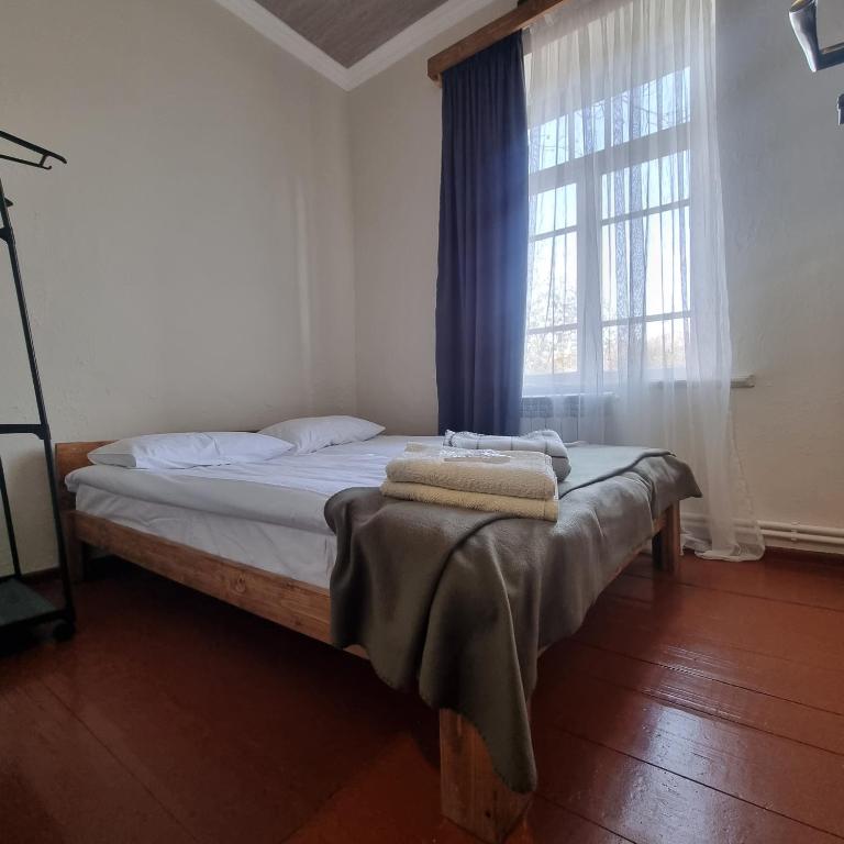 a bed in a room with a window at Hooni_guesthouse in Odzun