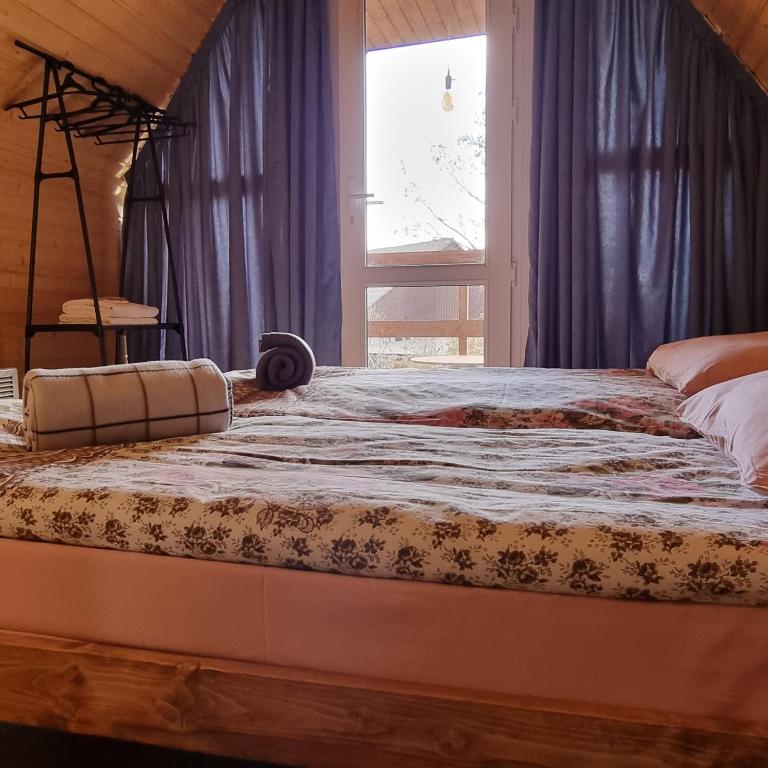 a large bed in a room with a window at Hooni_guesthouse in Odzun