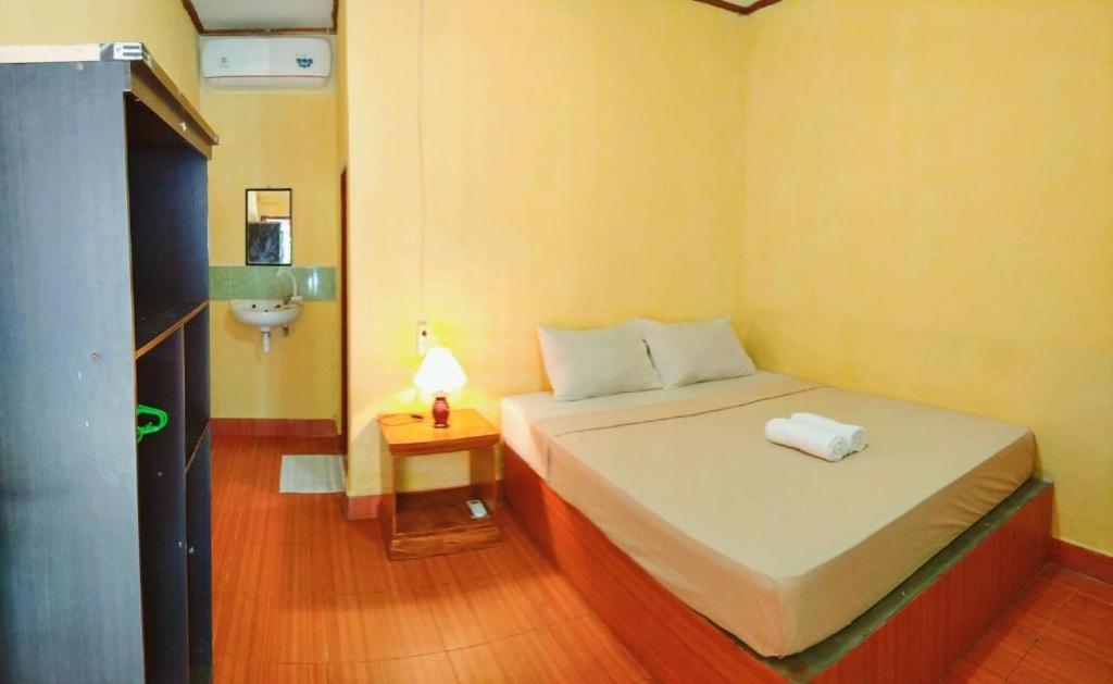 Katil atau katil-katil dalam bilik di Kuta Garden Guesthouse