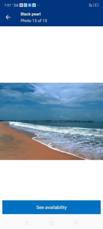 a picture of a beach with a screenshot of a website at Black pearl in Alleppey