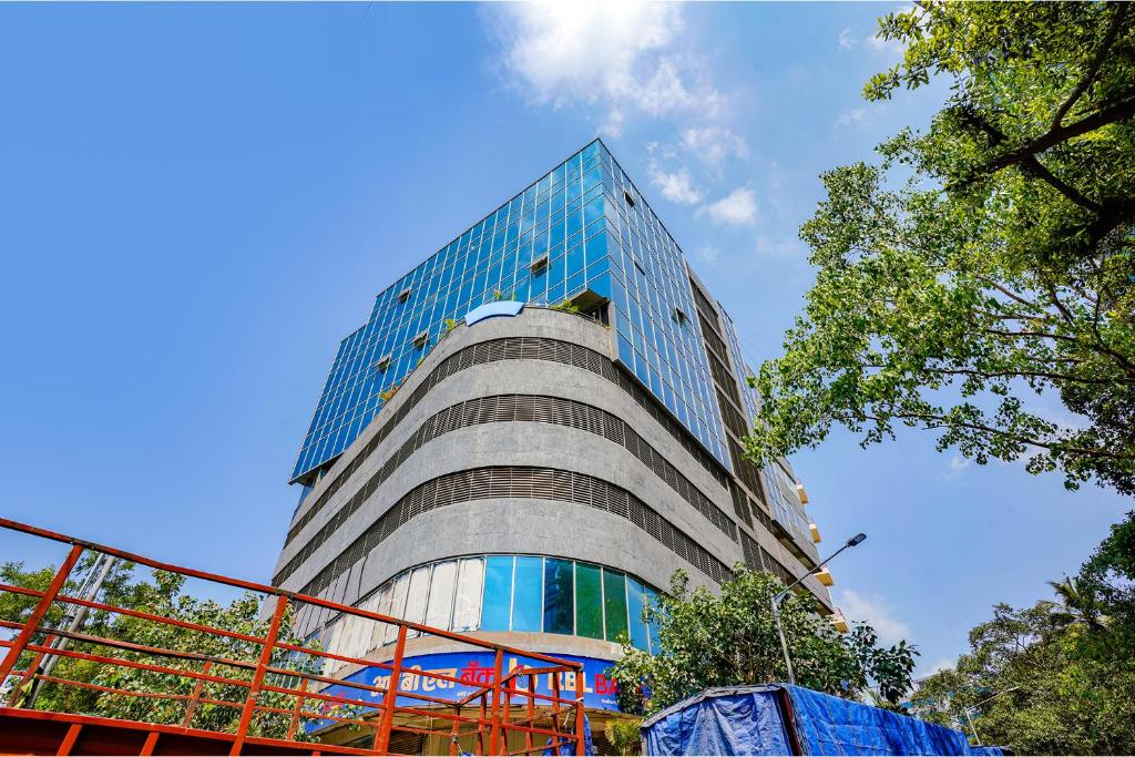 a tall building with glass windows on the side of it at The Azure in Mumbai