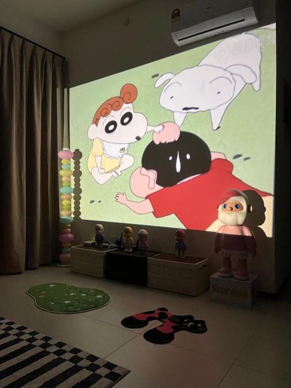 a room with a large screen with cartoon characters on it at Urban Suites @Jelutong Georgetown in Jelutong