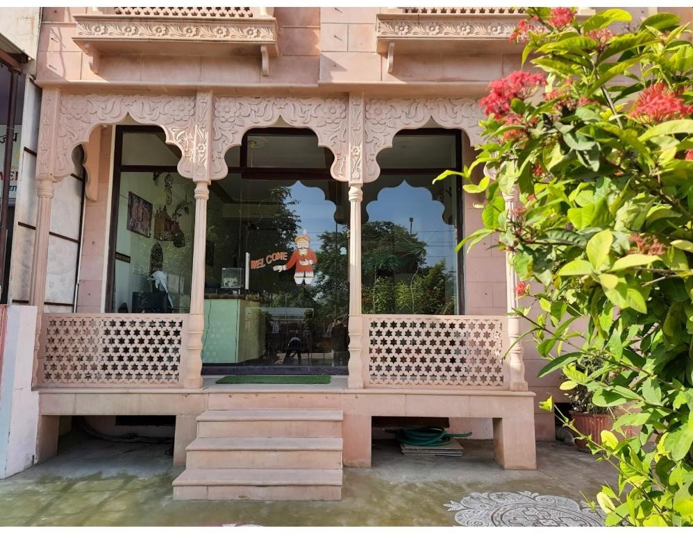 a building with a bench in front of a window at Hotel Ranthambhore Palace, Sawai Madhopur, RJ in Sawāi Mādhopur