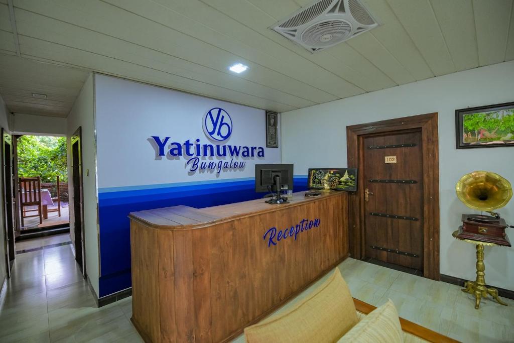 a reception desk in a room with a sign on the wall at Yatinuwara Bungalow in Anuradhapura