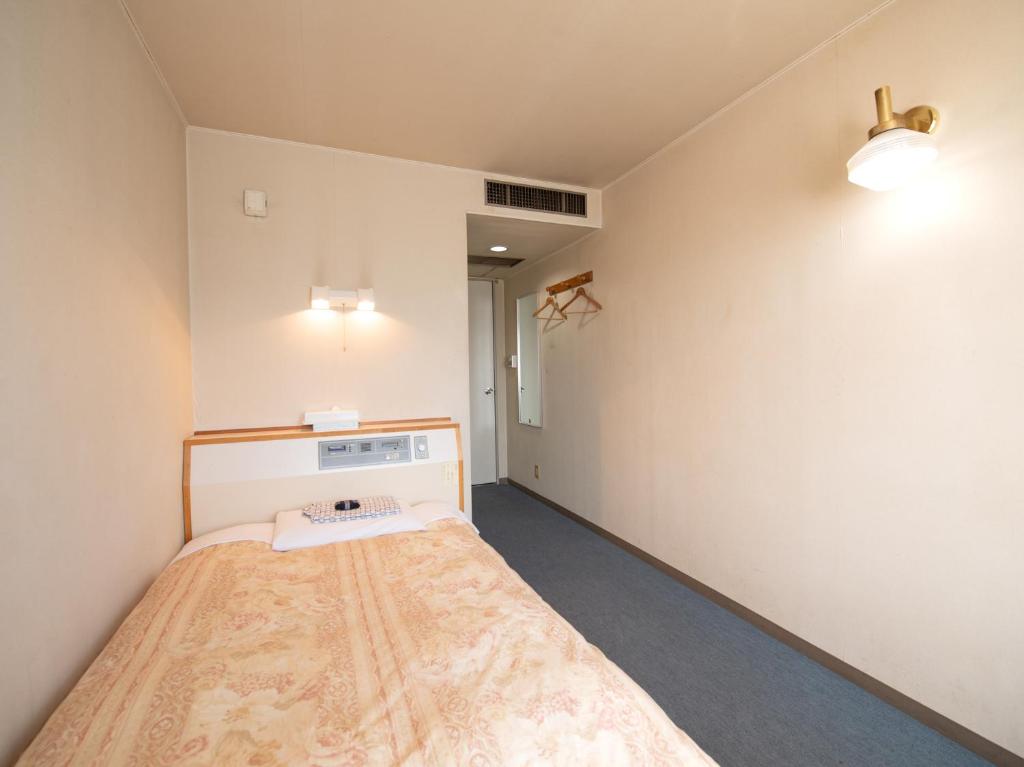 Postel nebo postele na pokoji v ubytování Tabist Hotel Sun Plaza Fuefuki Isawa