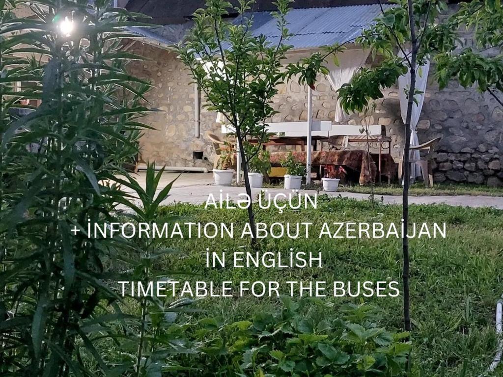 an information sign in front of a building at Ilgar's Hostel in Sheki