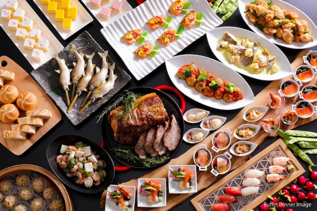 a table full of different types of food on plates at Hida Takayama Onsen Takayama Green Hotel - KEIO GROUP HOTELS - in Takayama