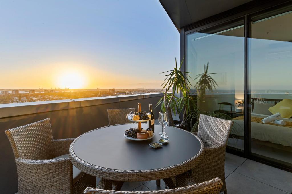 a table and chairs on a balcony with a view at Zi apartments - with Balcony, Bayview, Sauna and Pool in Melbourne