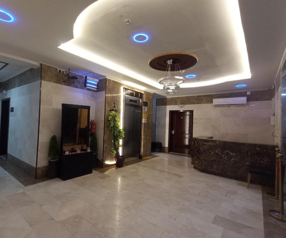 a lobby of a building with a ceiling with blue lights at شقق مفروشة شهري وسنوي in Obhor