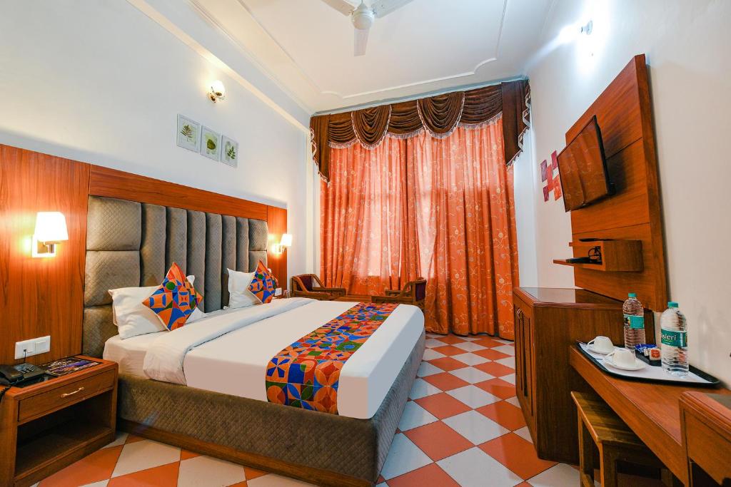 a hotel room with a bed and a desk at FabHotel Prime Hemkunth in Kasauli