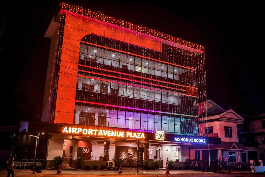a large building with an airport anytime plaza at Airport Avenue Plaza Cochin Airport in Nedumbassery