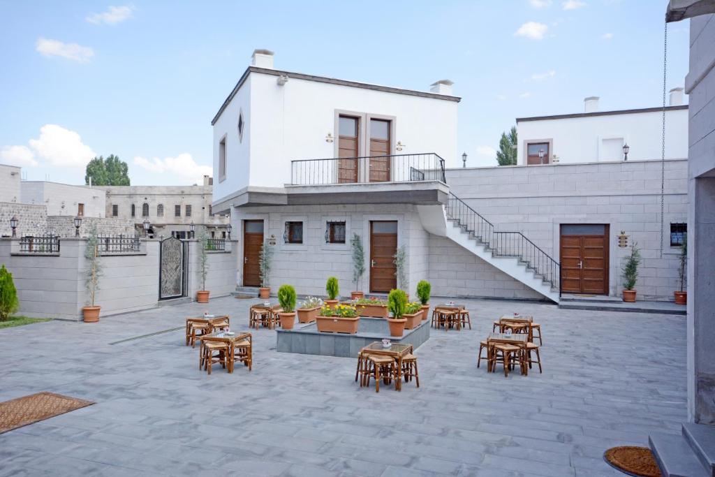 a patio with tables and chairs in front of a building at Setenonu 1892 Hotel in Kayseri