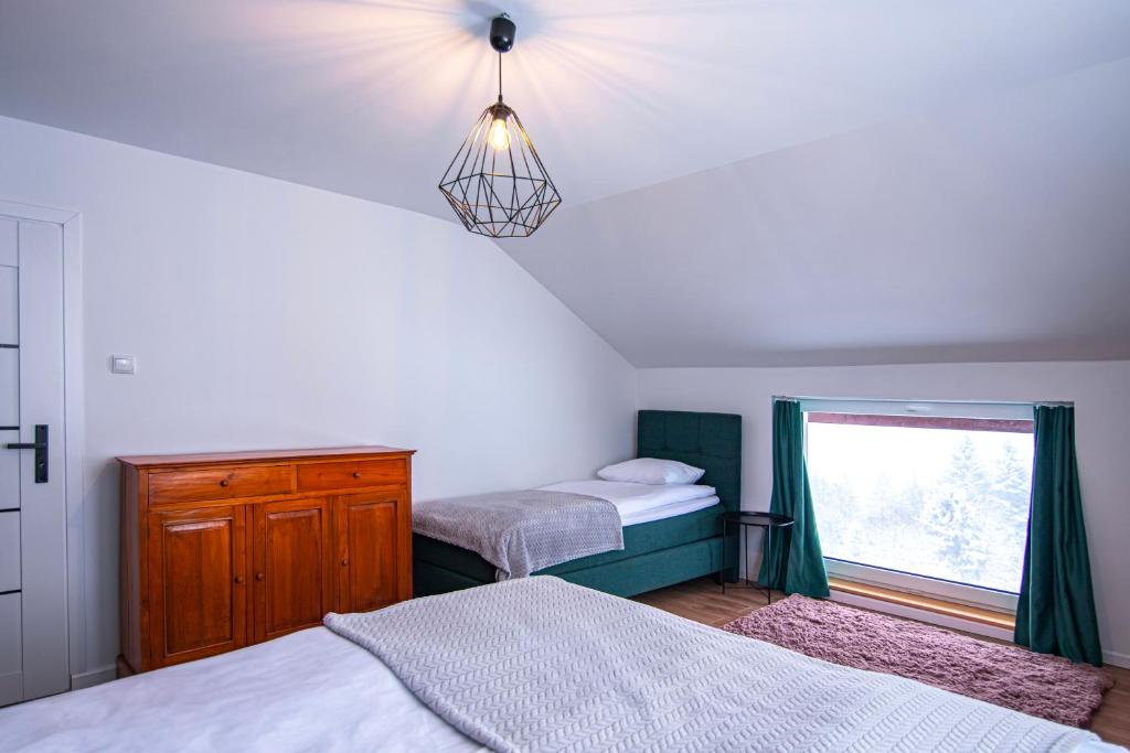 Posteľ alebo postele v izbe v ubytovaní Apartamenty 8 i 10 osobowe Koniakówka Resort