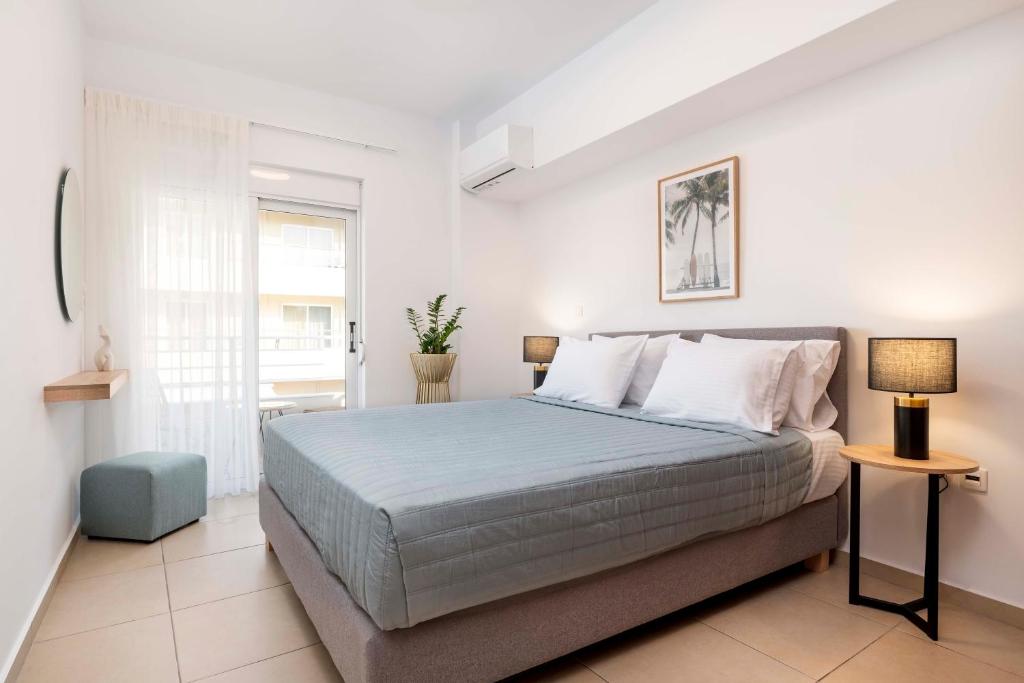 a bedroom with a large bed and a window at Gaia 1 - 5 min to Beach in Kos