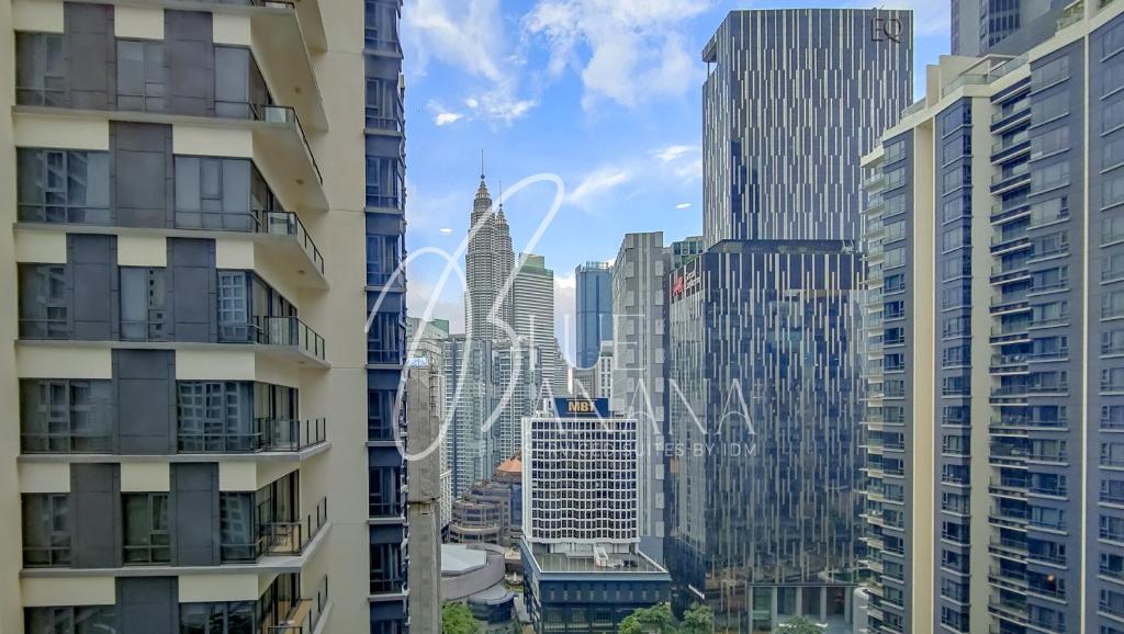a view of a city from between two buildings at St Mary Luxury Signature Suites, KLCC by BlueBanana in Kuala Lumpur