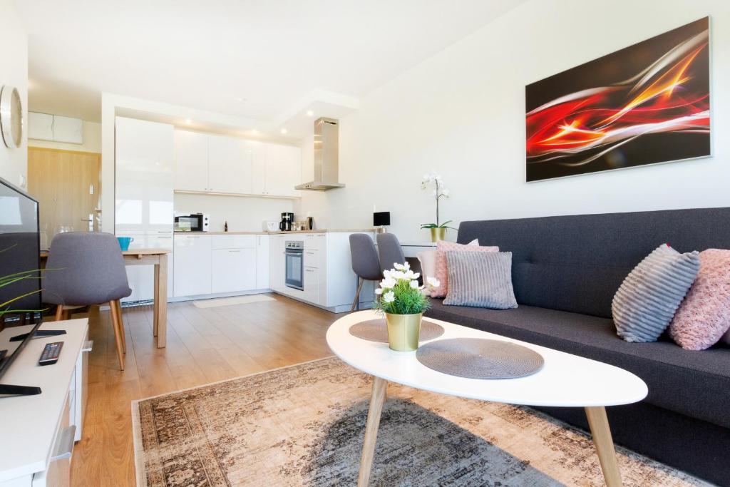 a living room with a couch and a table at Apartment in Northern Gdynia by Renters in Gdynia