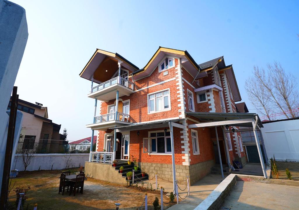 a large brick house is being built on a street at Moustache Srinagar in Srinagar