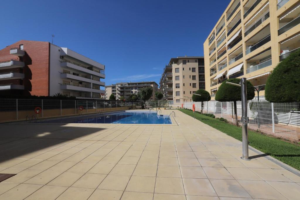 a swimming pool in the middle of a city at DIFFERENTFLATS Aquario in La Pineda
