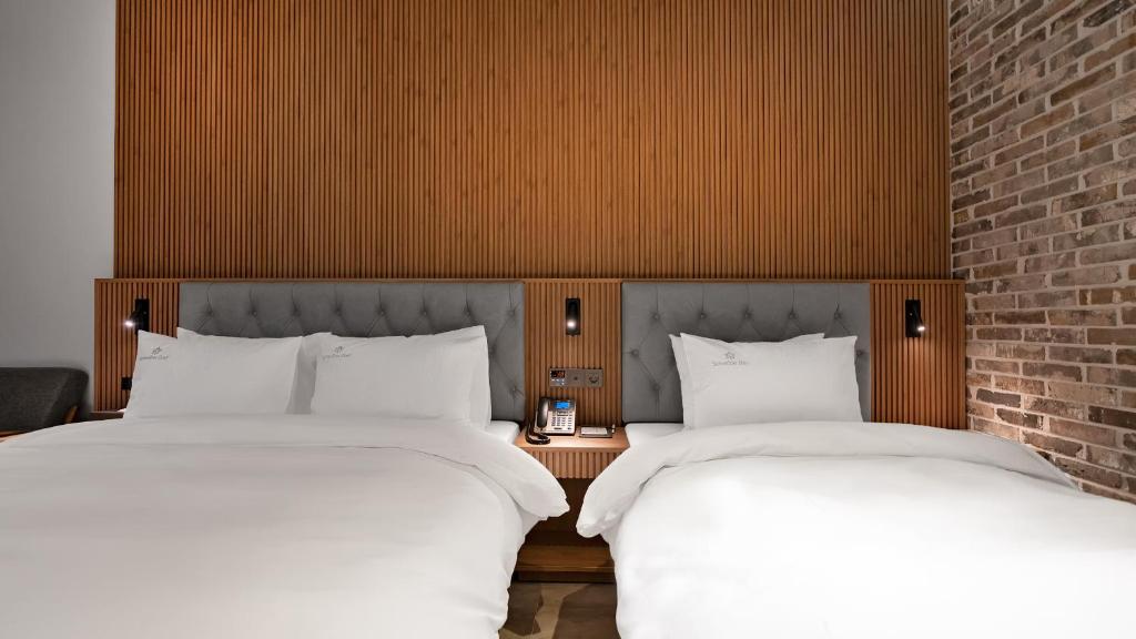 Postel nebo postele na pokoji v ubytování Hotel Schweizer Dorf Cheonan