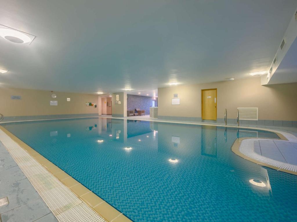 a large swimming pool in a large building at 3 Bed in Ullswater 85896 in Penruddock