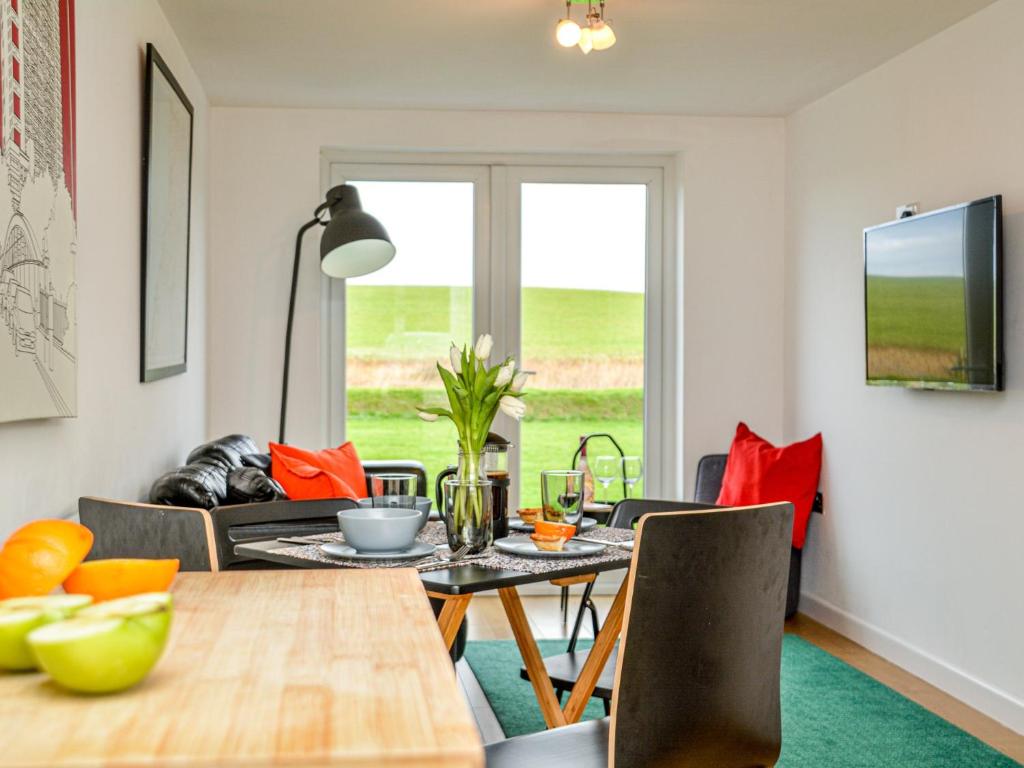 a dining room with a table and chairs at 2 Bed in Widemouth Bay 86152 in Marhamchurch
