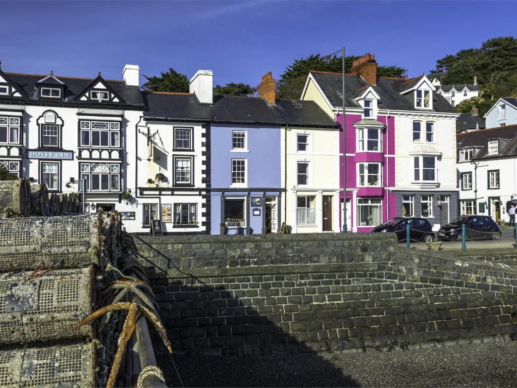 a group of houses with stairs in front of them at 2 Bed in Aberdovey DY004 in Aberdyfi