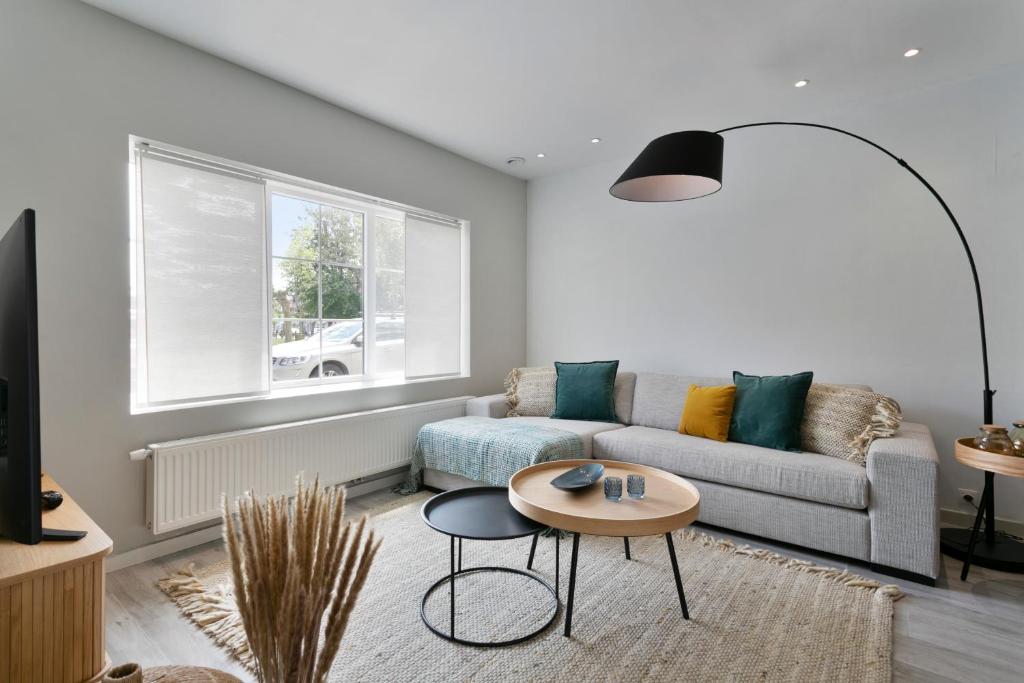 a living room with a couch and a table at Het Zwinhuis - Spacious and comfortable family home near 't Zwin in Knokke-Heist