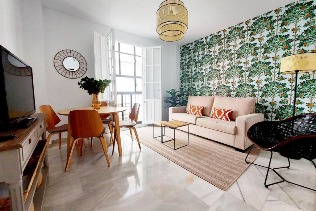 a living room with a couch and a table at Apartamento Azahar Alfonso XII in Seville