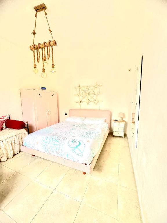 a bedroom with a bed and a chandelier at Relax House in Bari