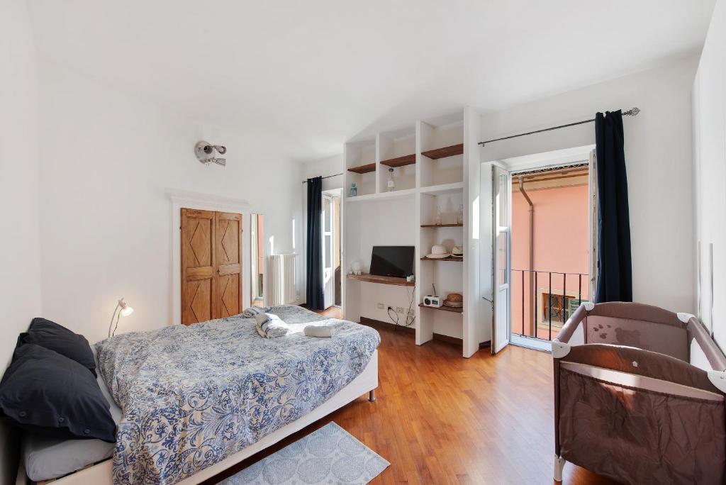 1 dormitorio con 1 cama y TV en Maria's home, en Ovada
