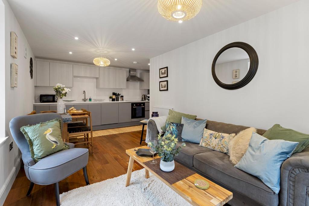 a living room with a couch and a table at Captain's Retreat in Torquay