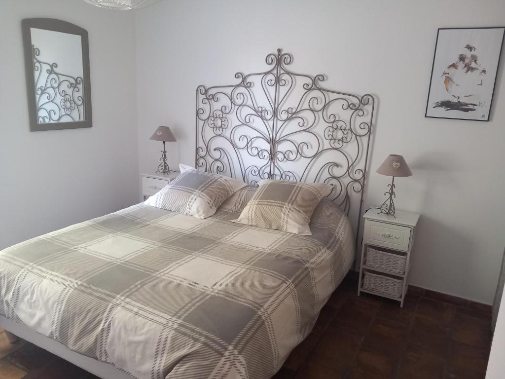 una camera con un grande letto e due comodini di Mas Sicard chambre d'hôtes en Camargue a Arles
