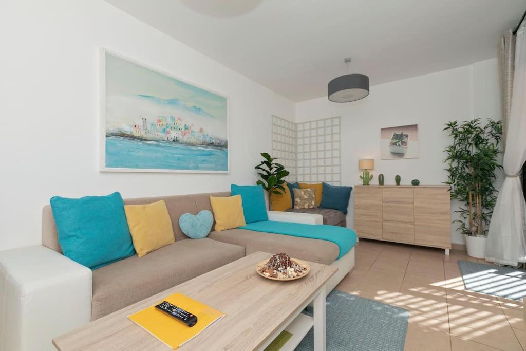 a living room with a couch and a table at Lovely Spacious Apartment in San Isidro Tenerife in San Isidro