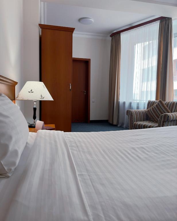 Postel nebo postele na pokoji v ubytování Aviatrans Hotel