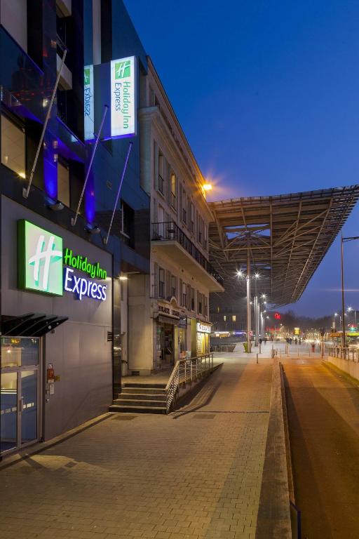 an empty street in front of a building at night at Holiday Inn Express Amiens, an IHG Hotel in Amiens