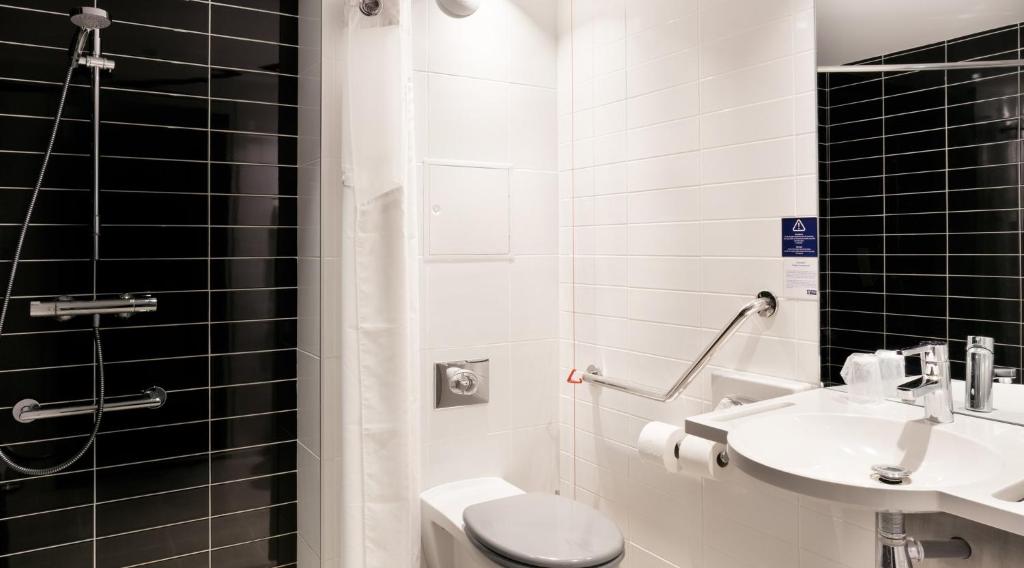 a bathroom with a toilet and a sink at Holiday Inn Express Amiens, an IHG Hotel in Amiens