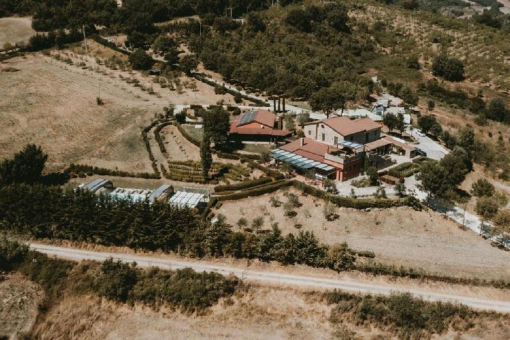 an aerial view of a house on a hill at La Foresteria di San Leo in Trivigno